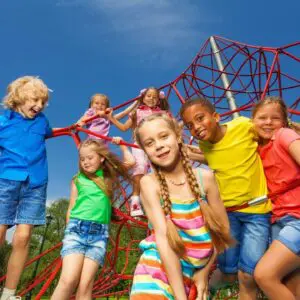 Children playing on a red rope climbing frame.